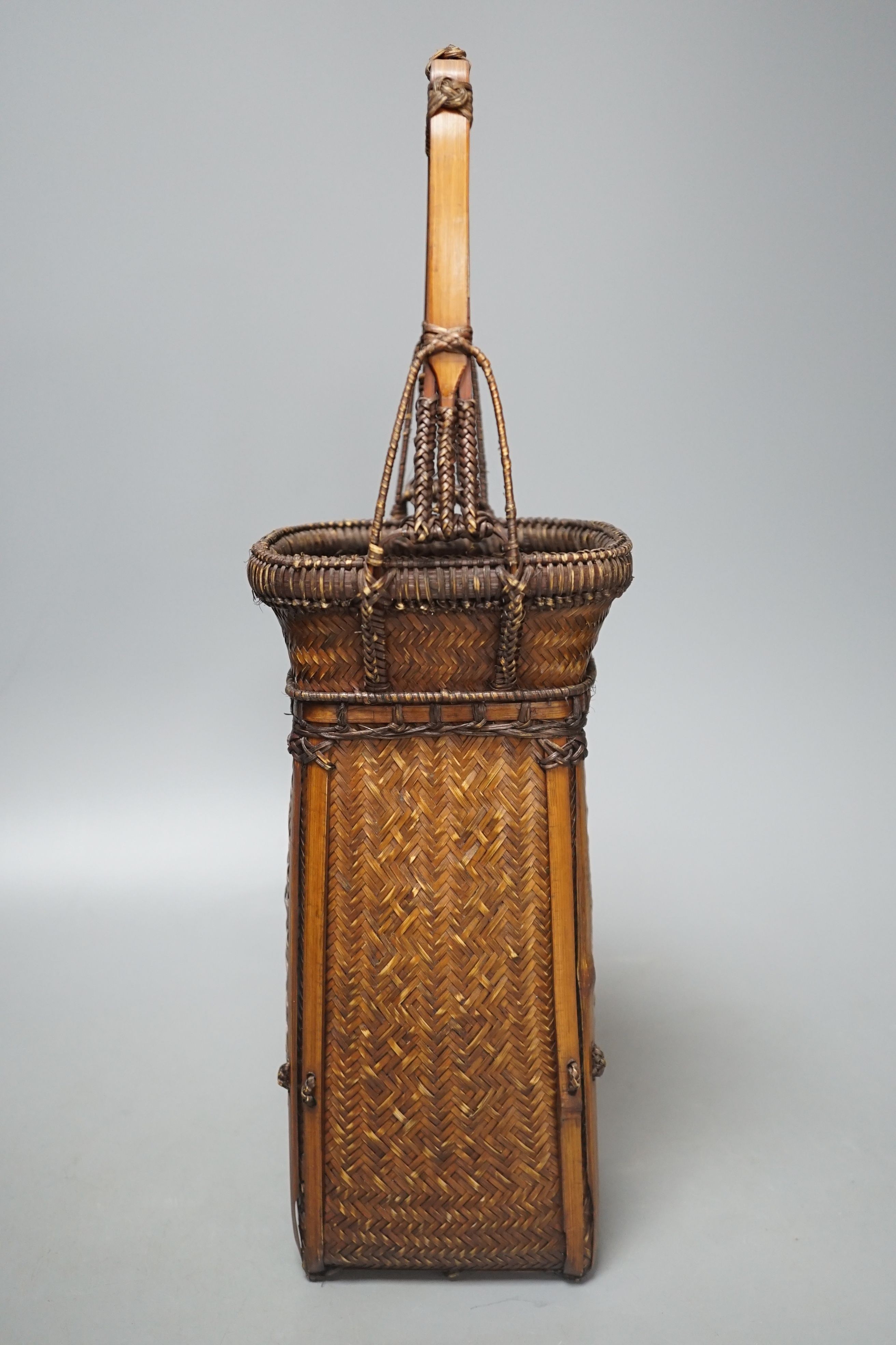 A Japanese wicker Ikebana flower basket, 38.5 cms high.